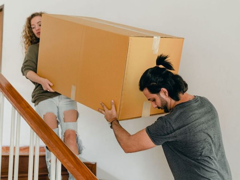 Payne Free Moving crew carrying boxes up the front stoop of a Capitol Hill rowhouse in Washington, DC